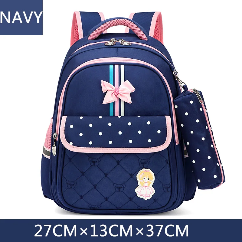 Sac à dos scolaire pour enfants design ludique couleur bleu marine rose et turquoise fermeture éclair bretelle