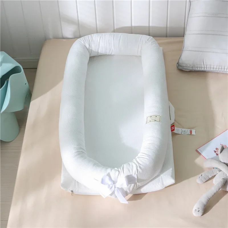 Coussin de sécurité bébé nouveauné portable lit d'appoint coton doux blanc minimaliste nœud décoratif facile à