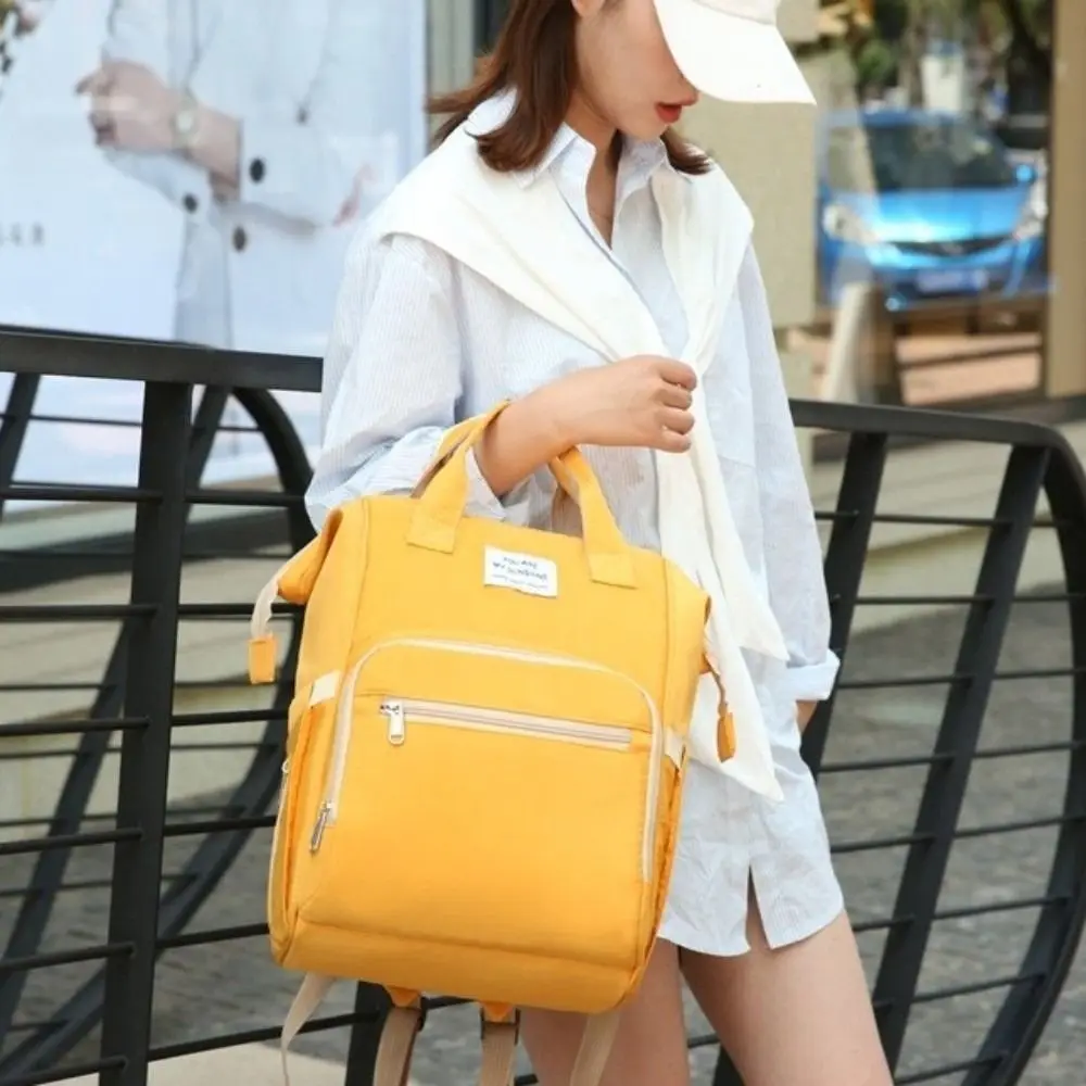 Sac à dos multifonctionnel pour maman portable grande capacité sac de change pour bébé léger et pliable design moderne rose