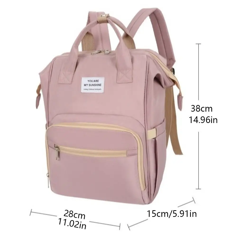 Sac à dos multifonctionnel pour maman portable grande capacité sac de change pour bébé léger et pliable design moderne rose