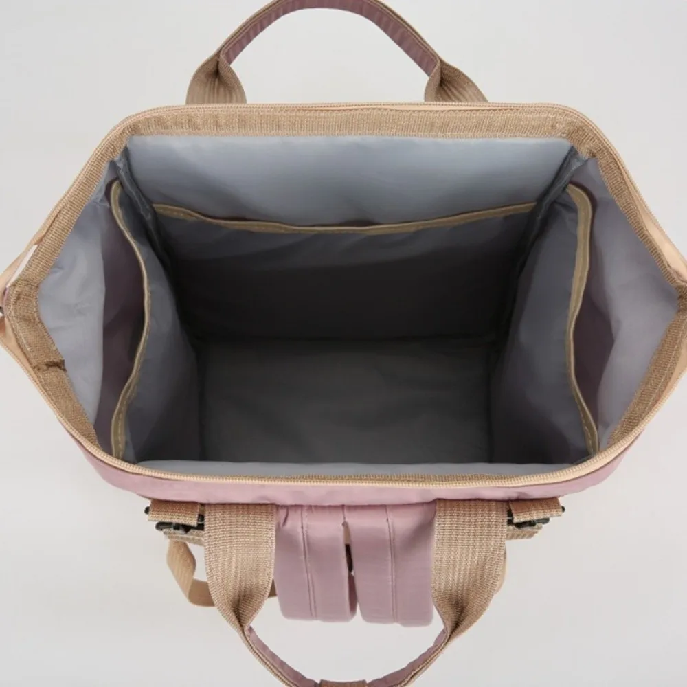 Sac à dos multifonctionnel pour maman portable grande capacité sac de change pour bébé léger et pliable design moderne rose