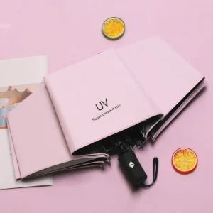 Parasol pliable protection UV rose pastel tissu synthétique manche noire design minimaliste