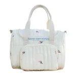 Sac à couches bébé multicompartiments tissu rembourré design floral offwhite et rose élégant pratique
