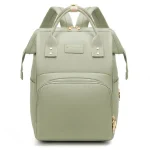 Sac à dos voyage bébé matériau simili cuir style moderne poche zippée bretelles ajustables couleur verte sac à couches portage bébé accessoires poussette confort urbain design élégant grande capacité usage quotidien durable