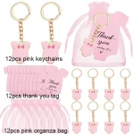 Ensemble de 12 porteclés bébé en plastique rose avec étiquettes remerciement et sac organza cadeau baby shower anniversaire