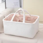 Sac de voyage bébé portable panier organisateur multifonctionnel doux tissu coton polyester texture douce poignées solides compartiments intérieurs blanc rayures pêche